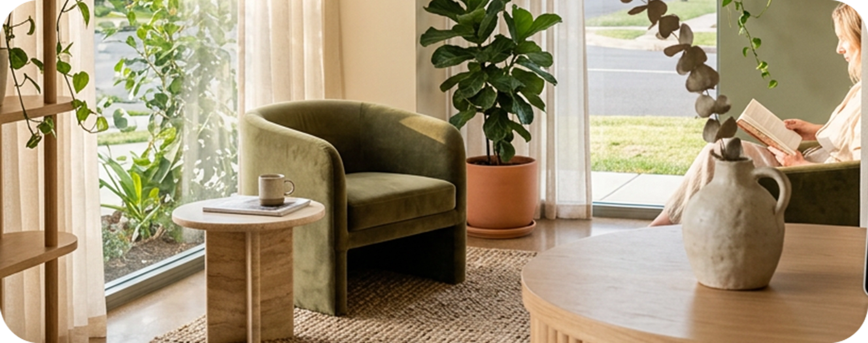 A serene waiting area in a psychology clinic featuring an
olive-green velvet barrel chair and a travertine side table with a mug.